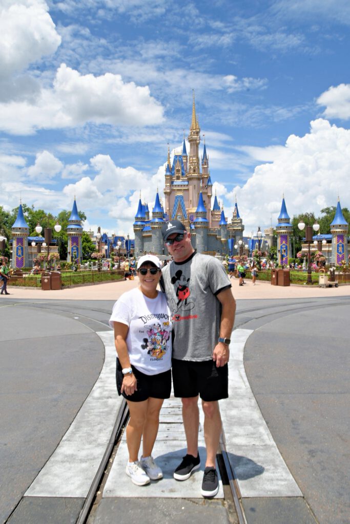 Vince from FitDisneyDad standing with his wife in front of Cinderella Castle at Magic Kingdom